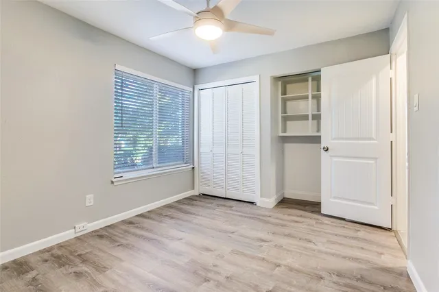 an empty room with windows and closet