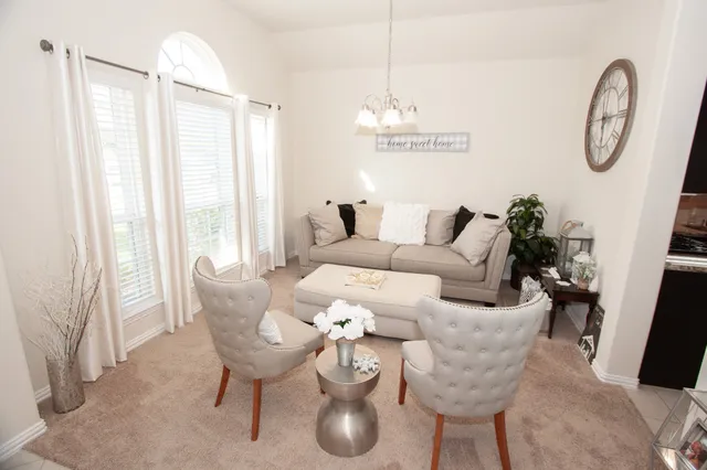a very nice looking dining room with furniture window and wooden floor