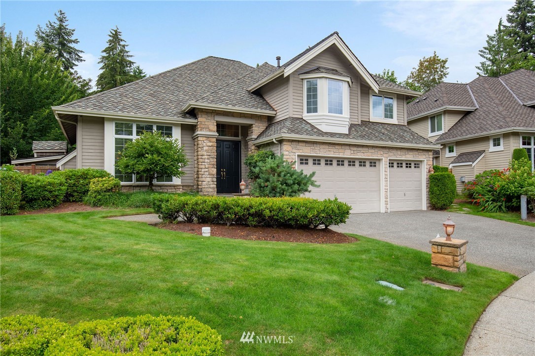 2411 201st Street Southeast Bothell, WA 98021 - Photo 1 of 24 a front view of a house with a yard and garage