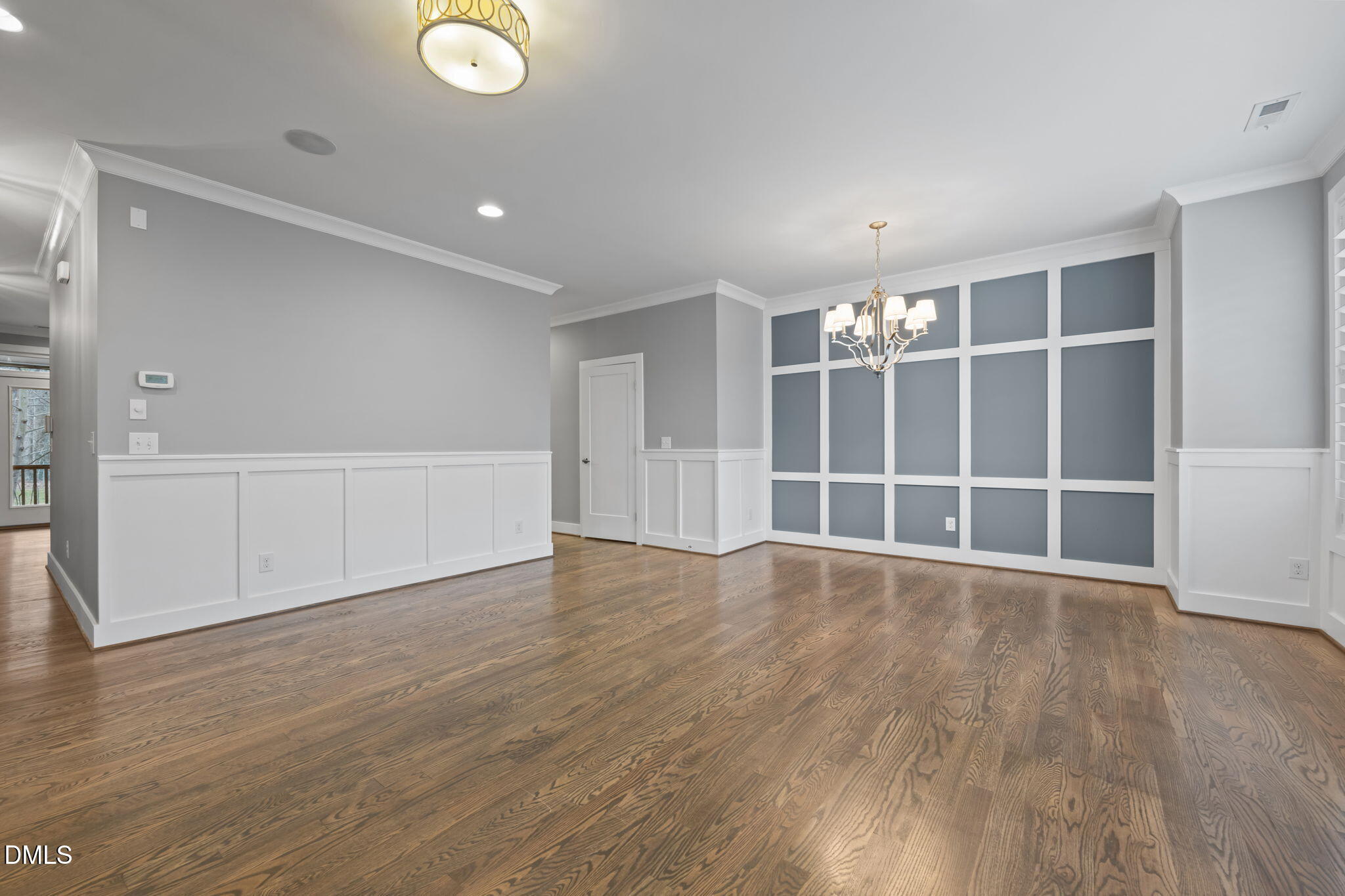 842 The Village Circle Raleigh, NC 27615 - Photo 4 of 36 a view of an empty room with wooden floor and windows