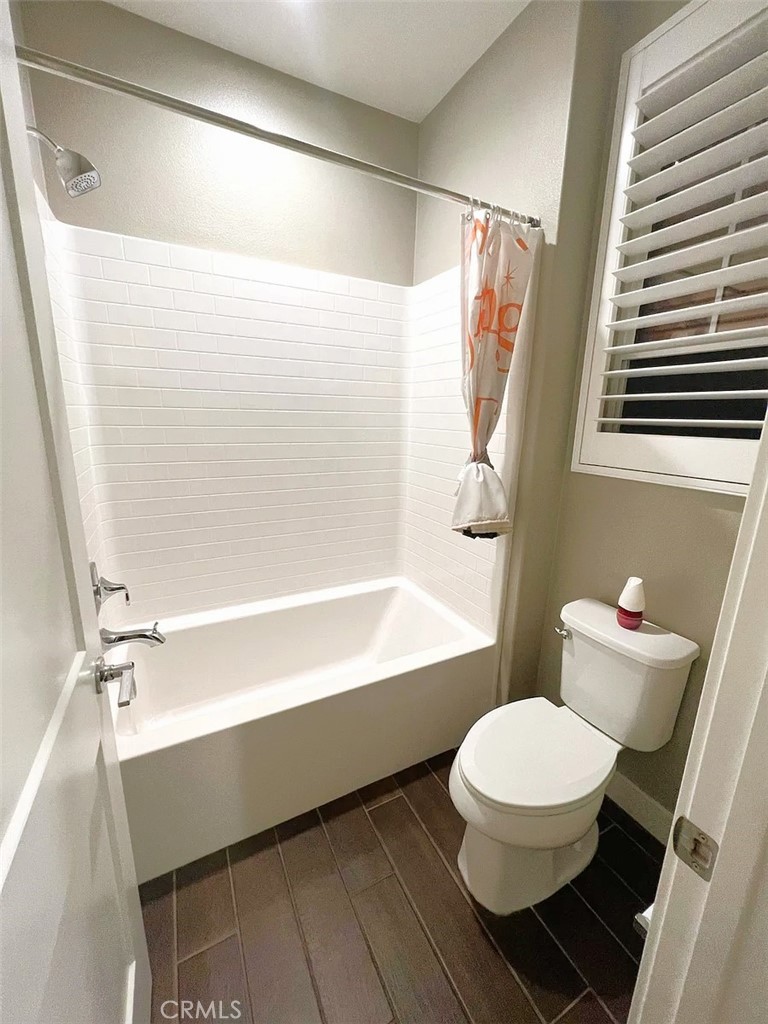 5177 Pomona Rincon Road Eastvale, CA 92880 - Photo 17 of 25 a bathroom with a toilet and a shower