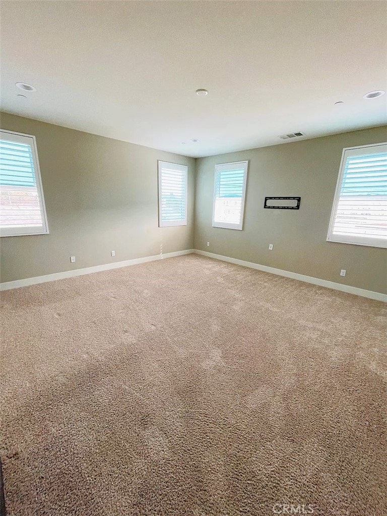 5177 Pomona Rincon Road Eastvale, CA 92880 - Photo 18 of 25 an empty room with windows and closet
