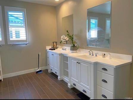 5177 Pomona Rincon Road Eastvale, CA 92880 - Photo 19 of 25 a spacious bathroom with a double vanity sink and mirror