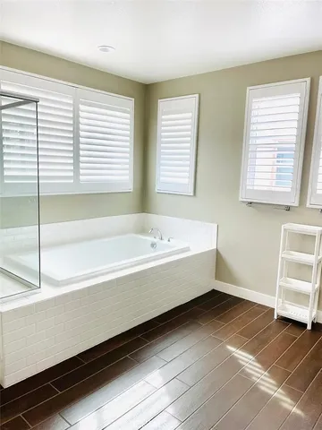 a bathroom with a bathtub and a window