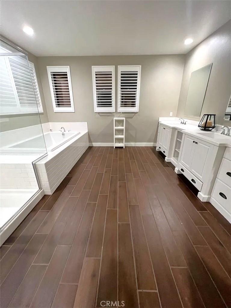 5177 Pomona Rincon Road Eastvale, CA 92880 - Photo 21 of 25 a bathroom with a sink a mirror and a bathtub