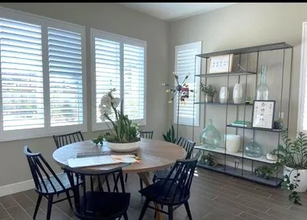 a view of a dining room with furniture and window