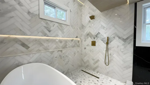 a bathroom with a bathtub and shower