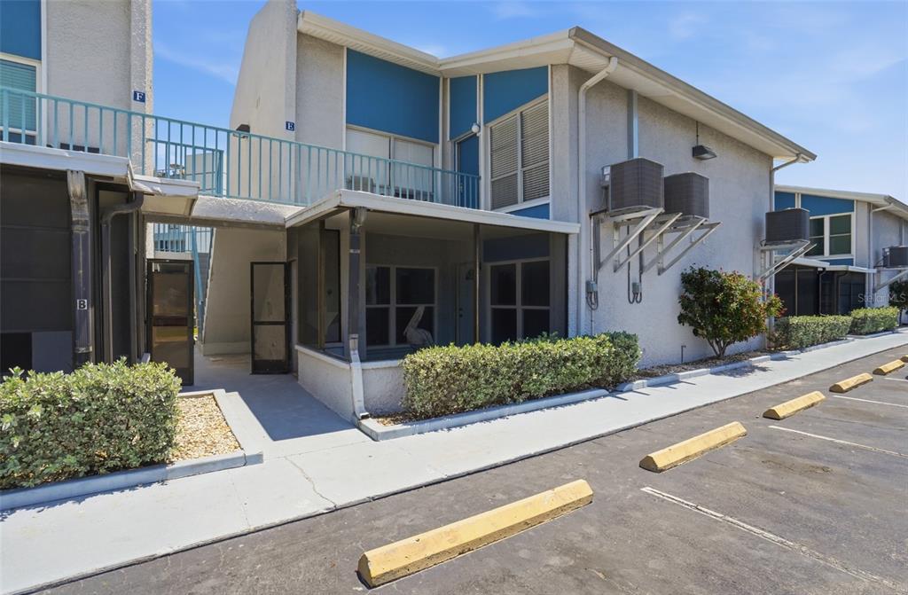155 Medallion Boulevard, Unit E Madeira Beach, FL 33708 - Photo 1 of 33 a front view of a house with garden