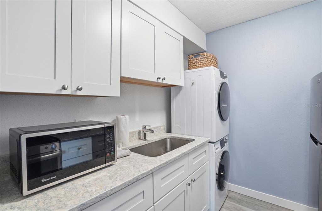 155 Medallion Boulevard, Unit E Madeira Beach, FL 33708 - Photo 12 of 33 a utility room with dryer and washer