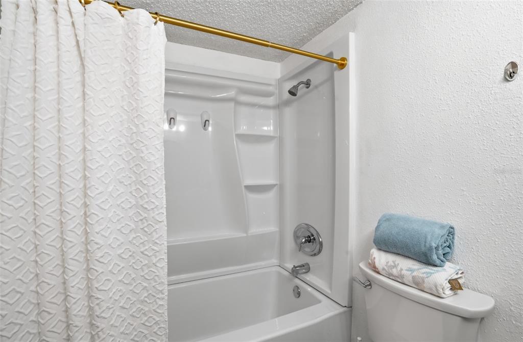 155 Medallion Boulevard, Unit E Madeira Beach, FL 33708 - Photo 21 of 33 a bathroom with a bathtub and toilet