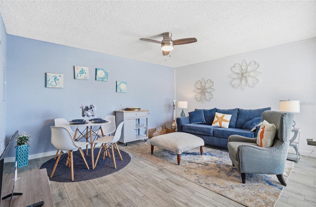 155 Medallion Boulevard, Unit E Madeira Beach, FL 33708 - Photo 5 of 33 a living room with furniture and a dining table