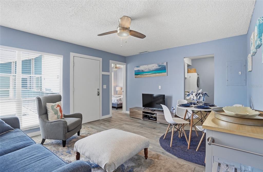 155 Medallion Boulevard, Unit E Madeira Beach, FL 33708 - Photo 7 of 33 a living room with furniture and a wooden floor