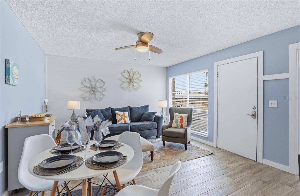 155 Medallion Boulevard, Unit E Madeira Beach, FL 33708 - Photo 10 of 33 a living room with furniture and wooden floor