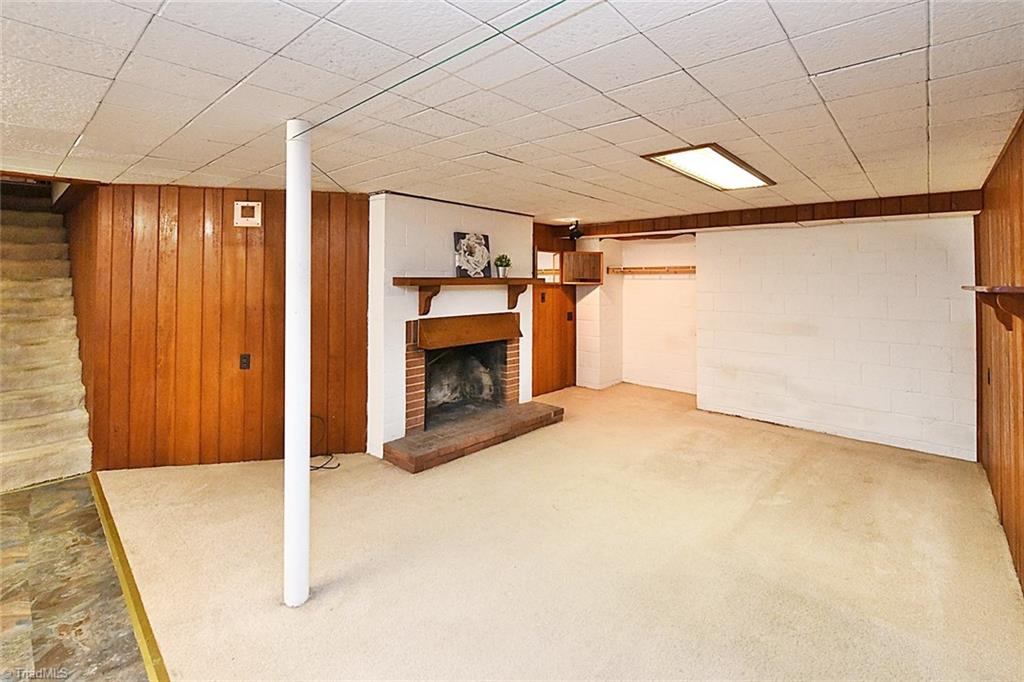 320 Doub Road Lewisville, NC 27023 - Photo 20 of 26 Partially finished basement with fireplace and mantle