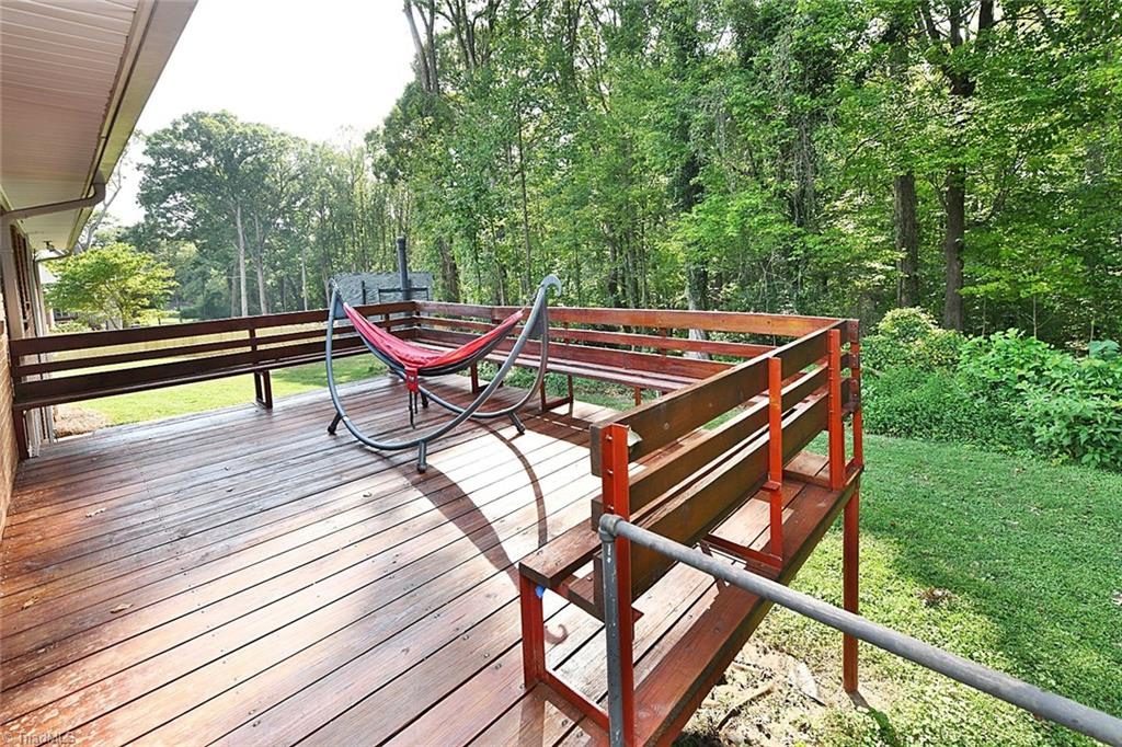 320 Doub Road Lewisville, NC 27023 - Photo 23 of 26 Nice sized deck out back overlooking back yard with tree lined privacy in the rear