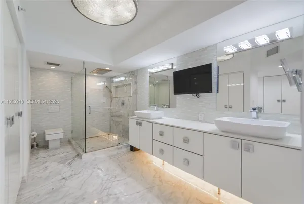 a bathroom with a shower and a glass door