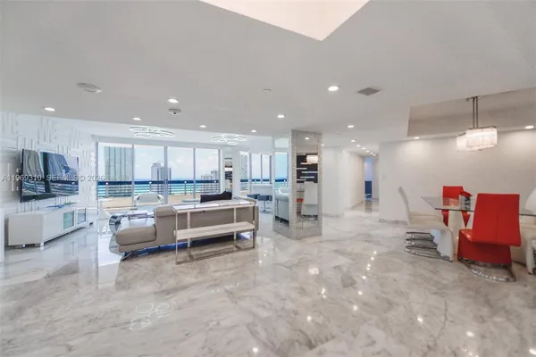 a living room with furniture and kitchen view