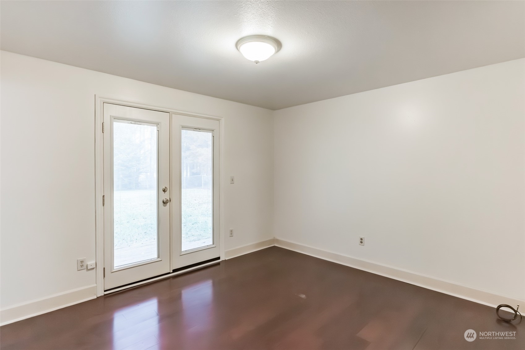 7920 187th Avenue Southwest Rochester, WA 98579 - Photo 18 of 28 an empty room with wooden floor and windows