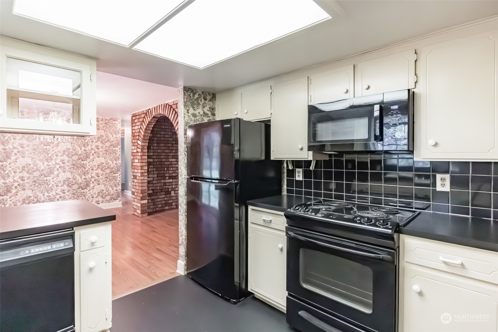 7920 187th Avenue Southwest Rochester, WA 98579 - Photo 10 of 28 a kitchen with granite countertop a stove microwave and refrigerator