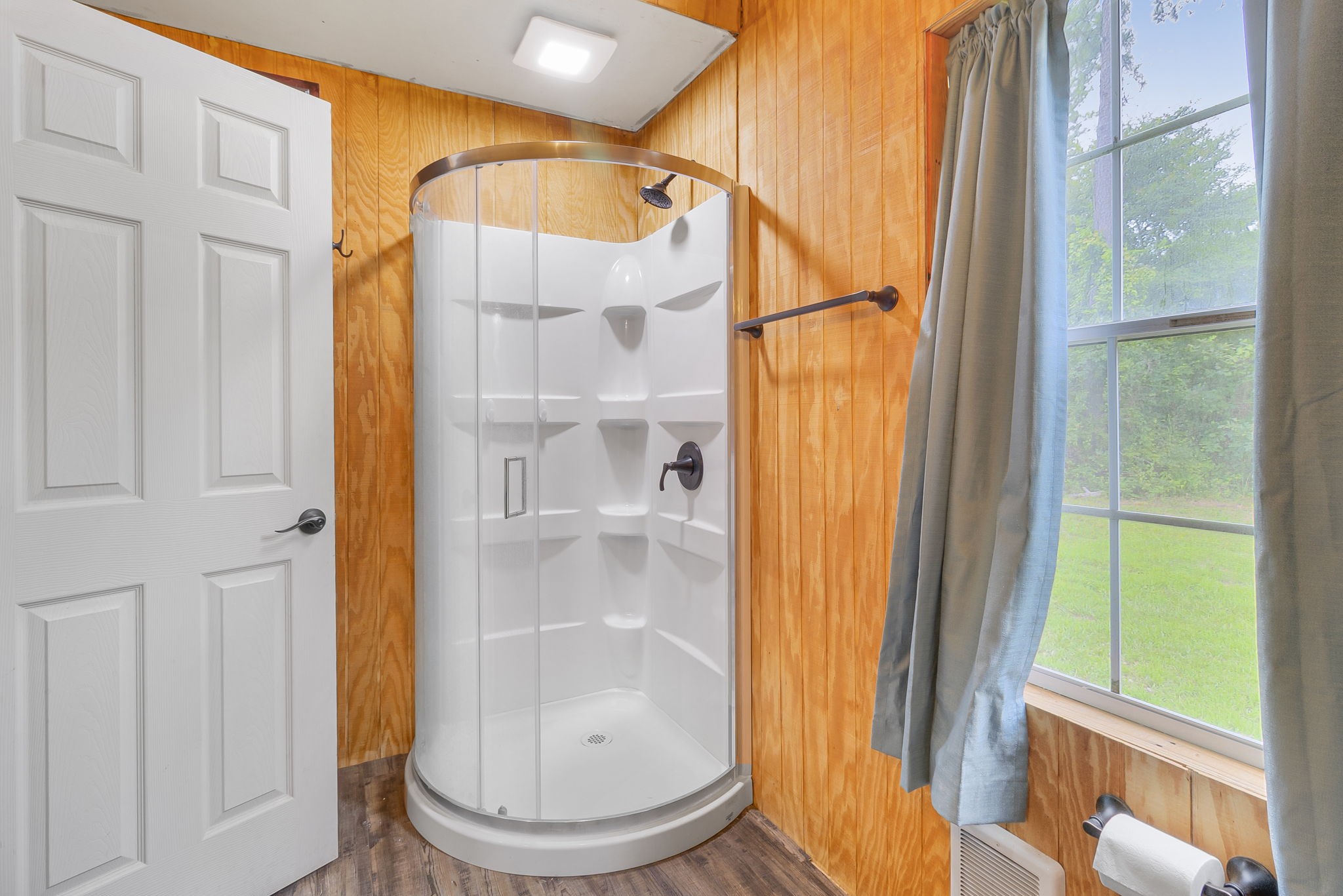 300 Collier Road Point Blank, TX 77364 - Photo 15 of 49 a bathroom with a glass shower door