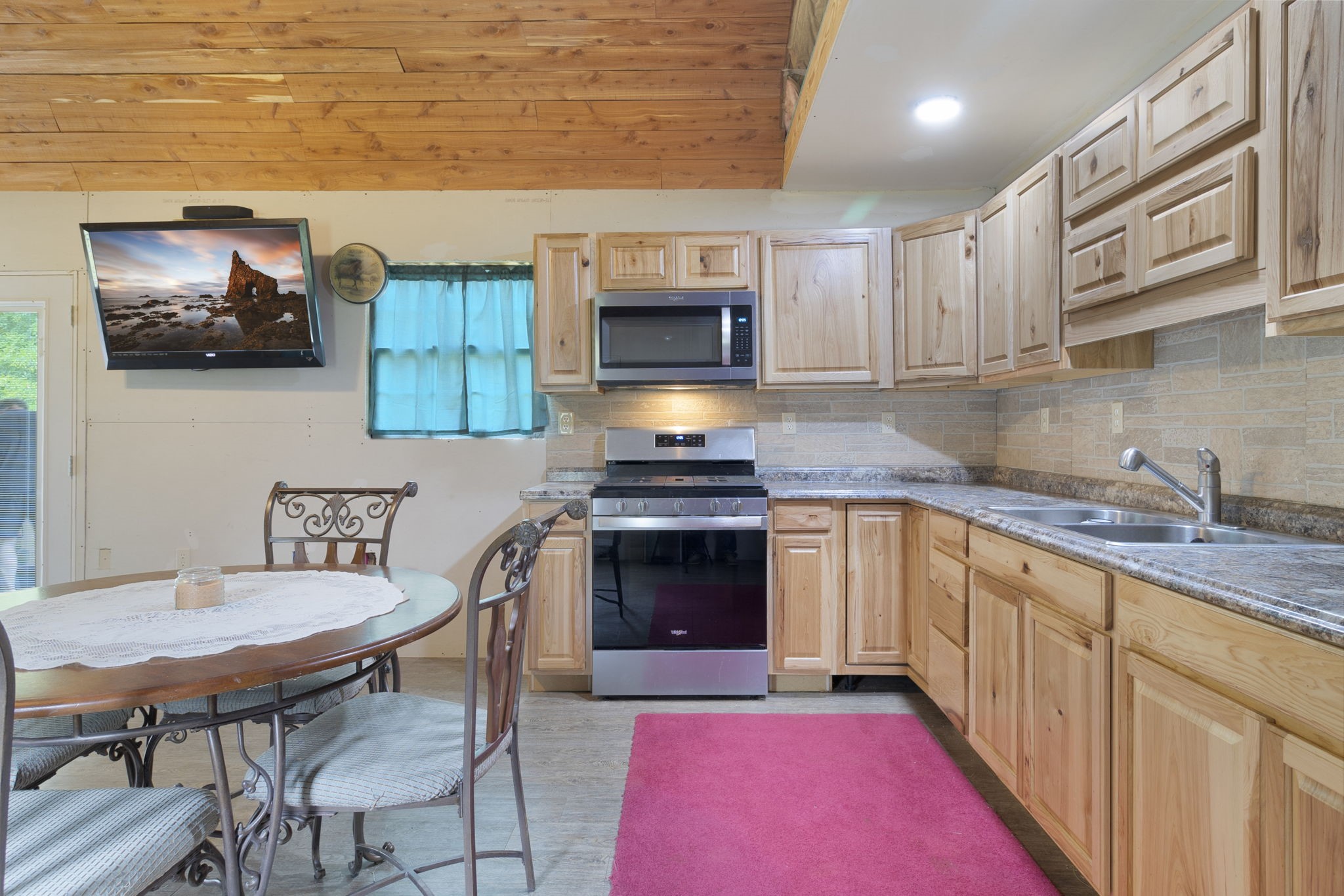 300 Collier Road Point Blank, TX 77364 - Photo 20 of 49 a kitchen with stainless steel appliances a stove a sink and a microwave
