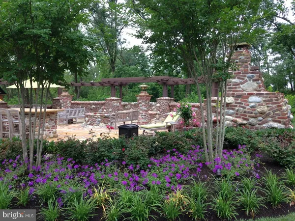 a view of a house with a garden and pathway