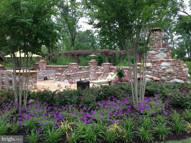 a view of a house with a garden and pathway