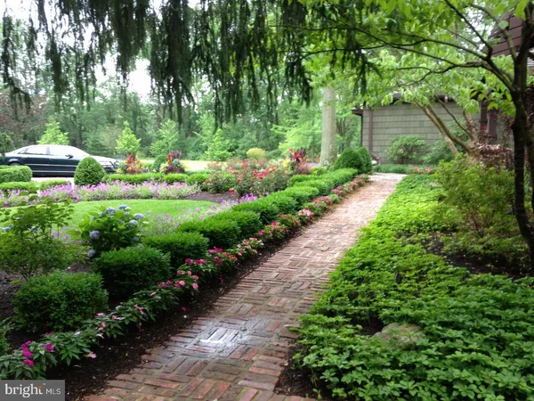 a view of a garden with flowers and trees