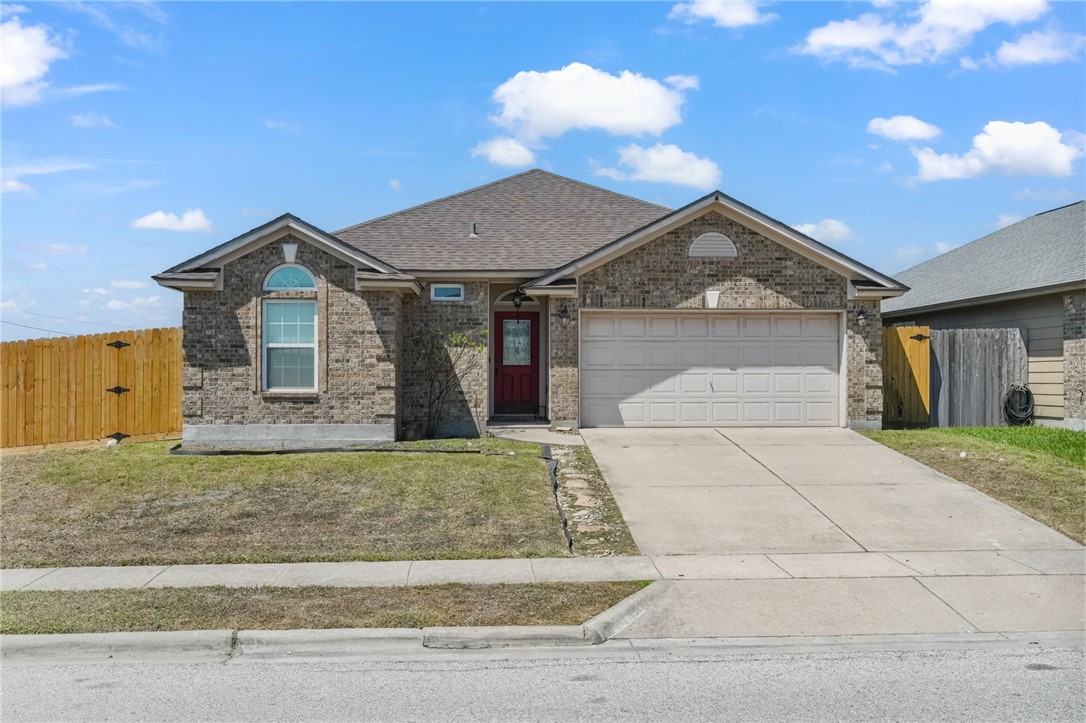 1000 Imperial Street Portland, TX 78374 - Photo 1 of 26 a front view of a house with a yard and garage