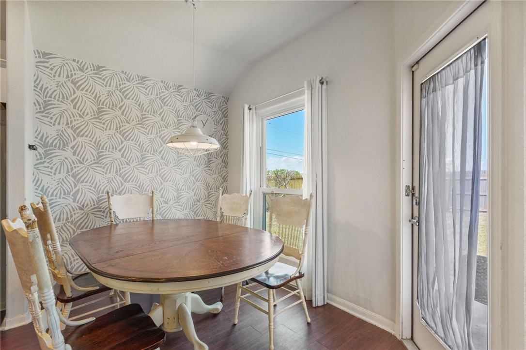 1000 Imperial Street Portland, TX 78374 - Photo 11 of 26 a view of a dining room with furniture and wooden floor