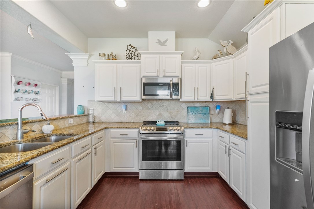 1000 Imperial Street Portland, TX 78374 - Photo 12 of 26 a kitchen with cabinets stainless steel appliances and wooden floor