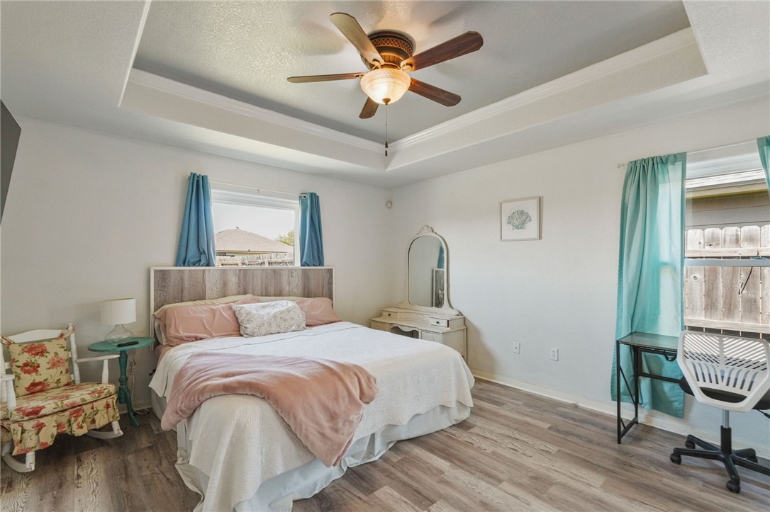 1000 Imperial Street Portland, TX 78374 - Photo 16 of 26 a bed room with a bed and a chandelier