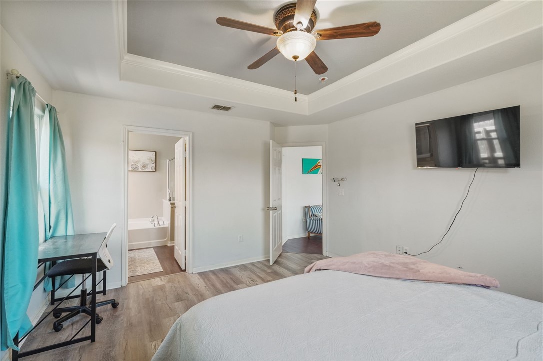 1000 Imperial Street Portland, TX 78374 - Photo 17 of 26 a bedroom with a bed and a flat screen tv