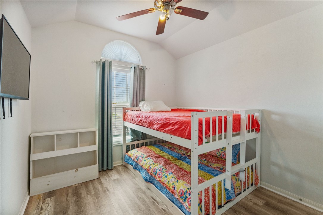 1000 Imperial Street Portland, TX 78374 - Photo 3 of 26 a bedroom with bed and a chandelier