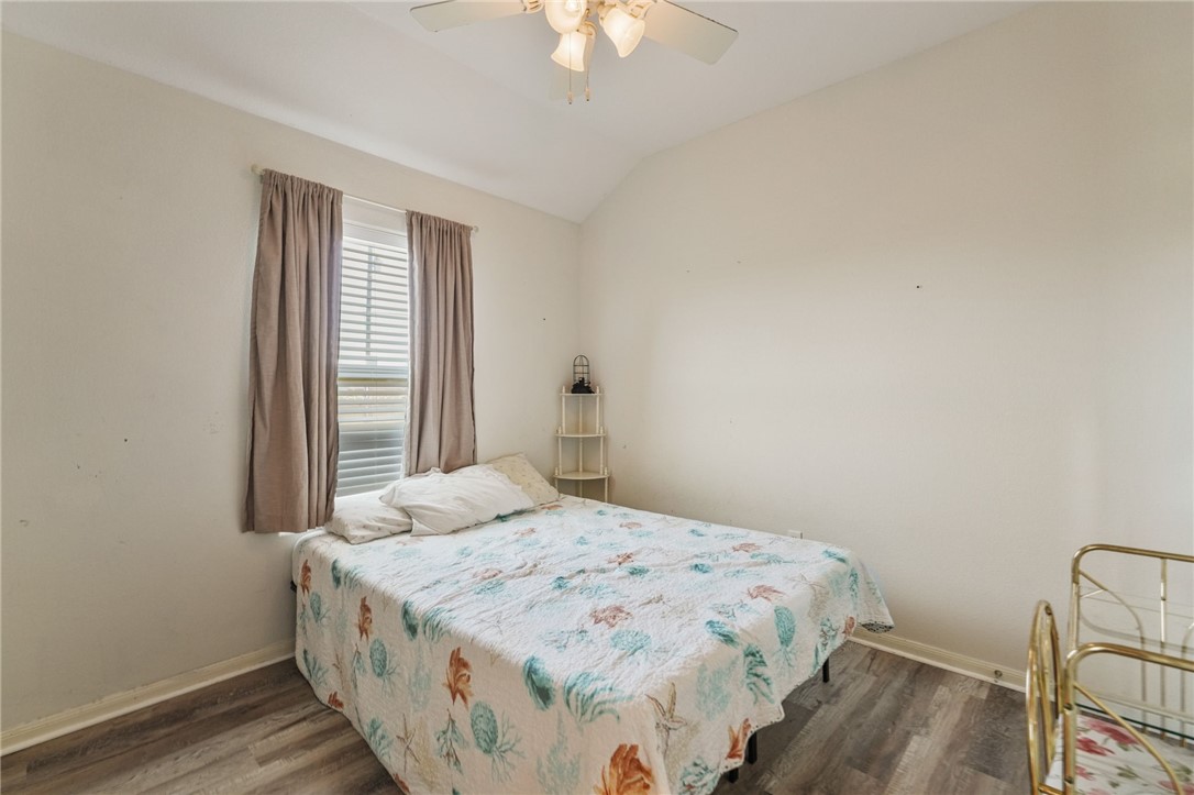 1000 Imperial Street Portland, TX 78374 - Photo 5 of 26 a bedroom with a bed and a chandelier