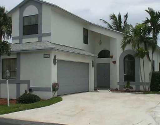 23360 Sedawie Drive Boca Raton, FL 33433 - Photo 1 of 6 a front view of a house with a yard