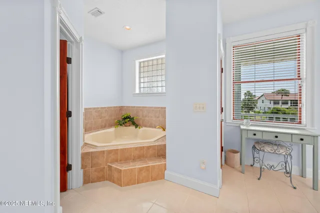 a view of walk in closet with clothes