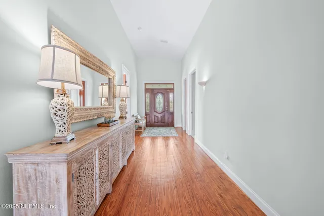 a view of a patio with a table and chairs potted plants with wooden fence