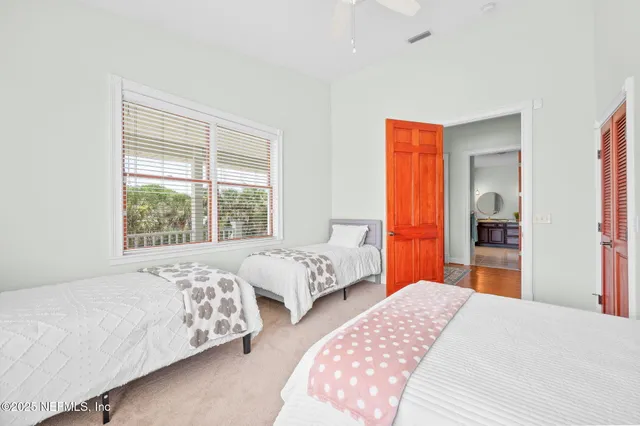 a view of a lake with a big yard and palm trees