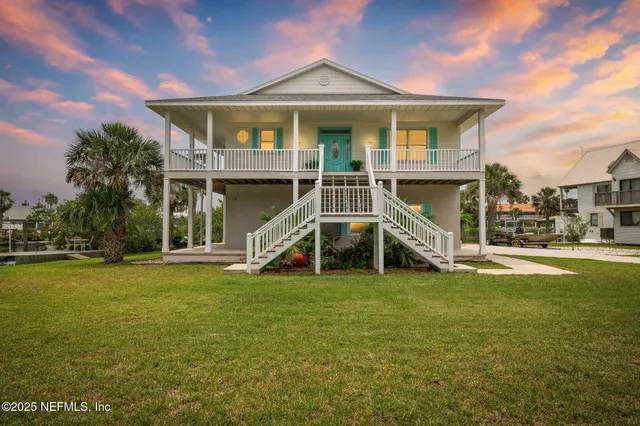 a view of a house with a yard and a porch