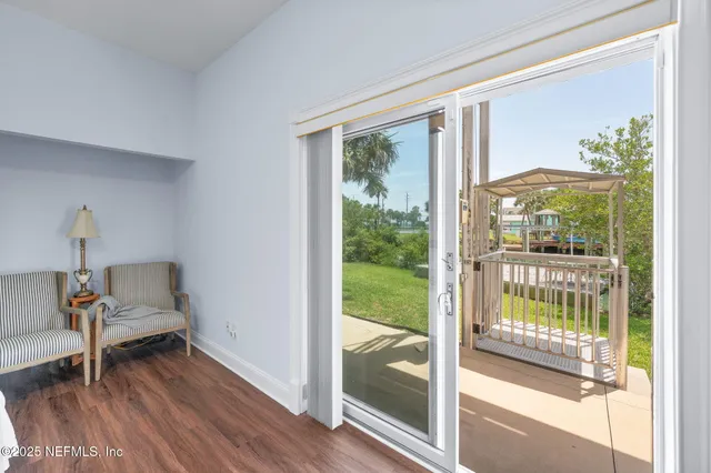 a view of a patio with table and chairs and potted plants