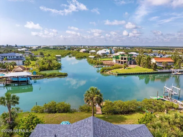 a view of swimming pool with outdoor seating and trees in the background