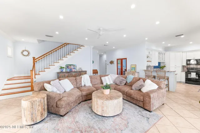 a living room with furniture and kitchen view