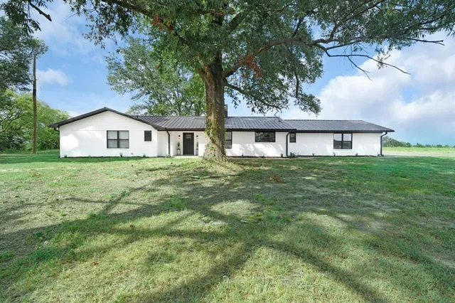 a house view with garden space and deck