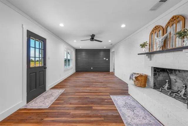 a hallway with an entryway and livingroom with furniture