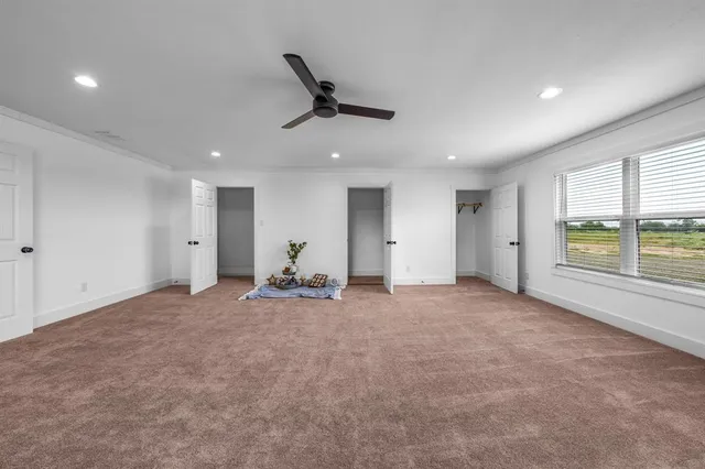 a view of a livingroom with a ceiling fan and window