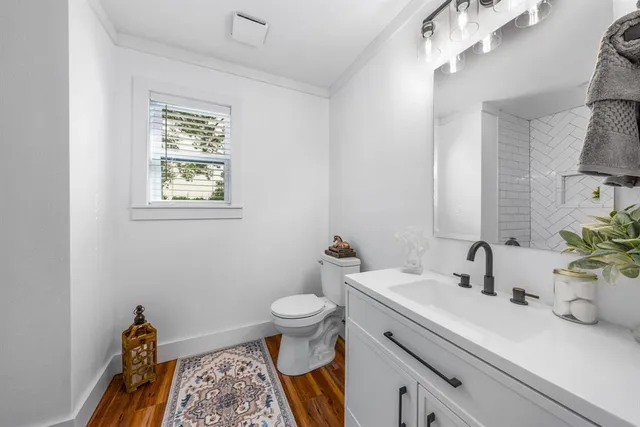 a bathroom with a sink a toilet and mirror