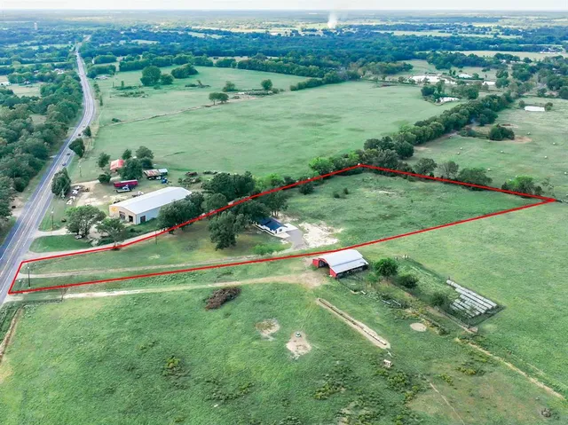 a view of a lush green field with clear sky