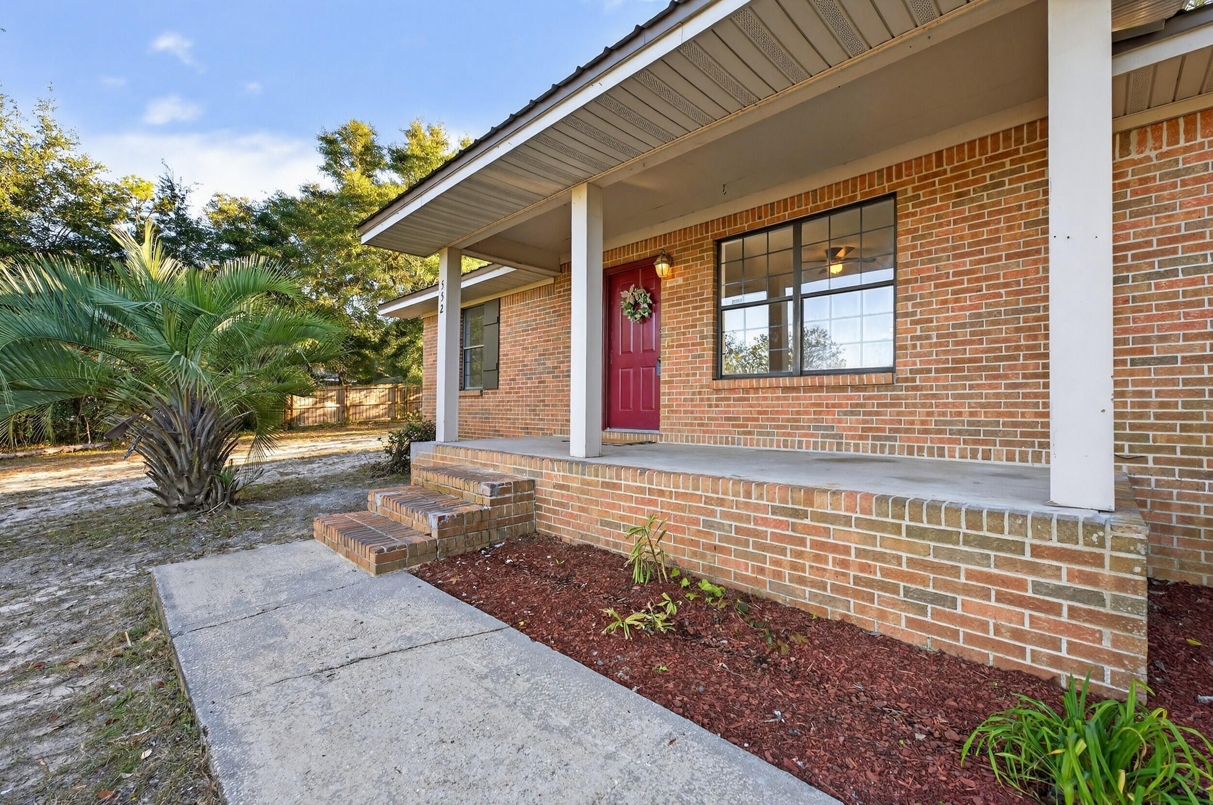 552 Roberts Drive DeFuniak Springs, FL 32433 - Photo 2 of 40 a front view of a house with a yard