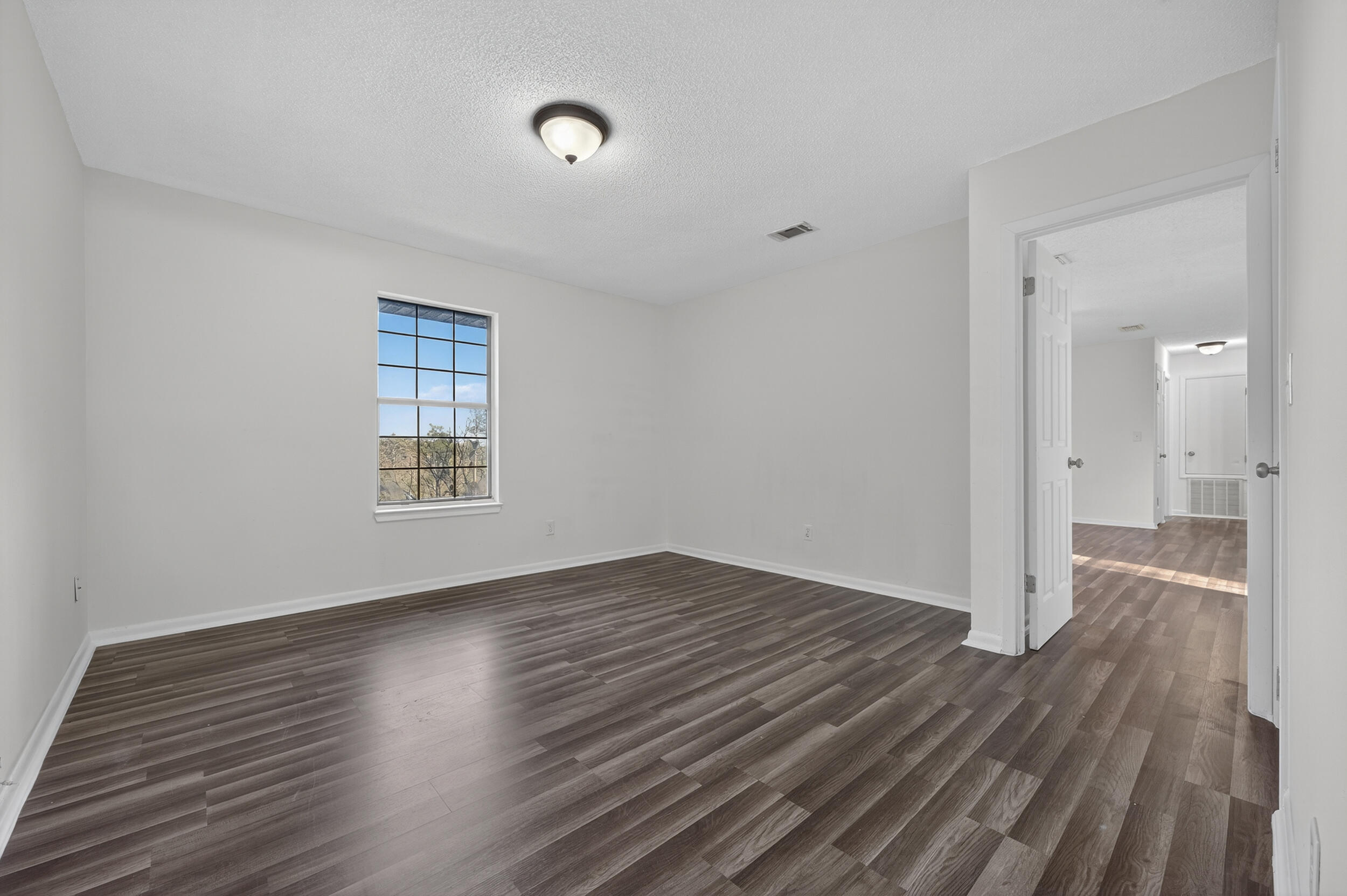 552 Roberts Drive DeFuniak Springs, FL 32433 - Photo 22 of 40 wooden floor in an empty room with a window